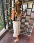 Silver kitten heel sandals worn with a long skirt