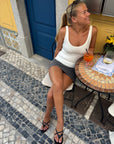Black kitten heel sandals worn at a cafe table