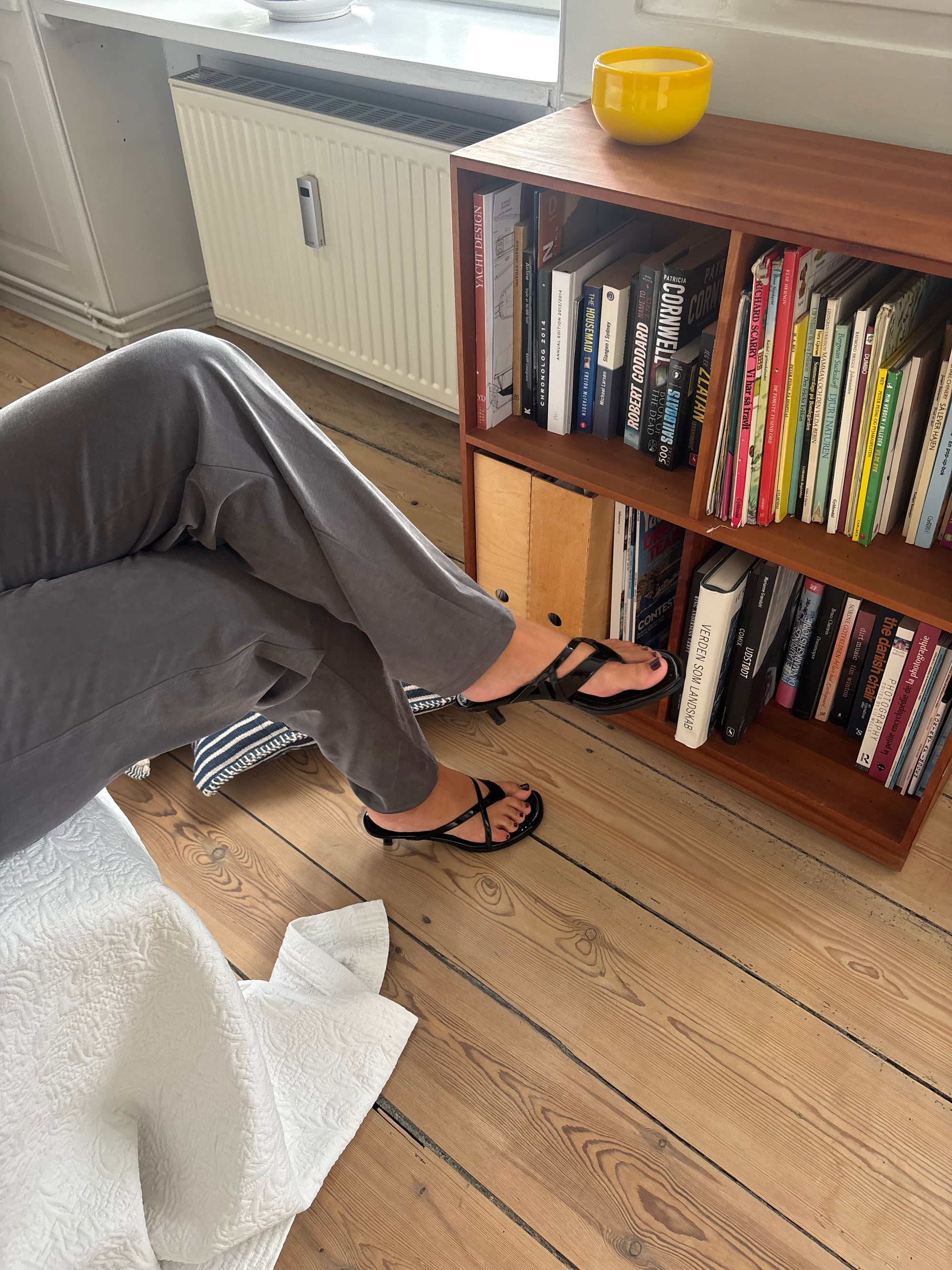 Black kitten heel sandals worn with grey trousers